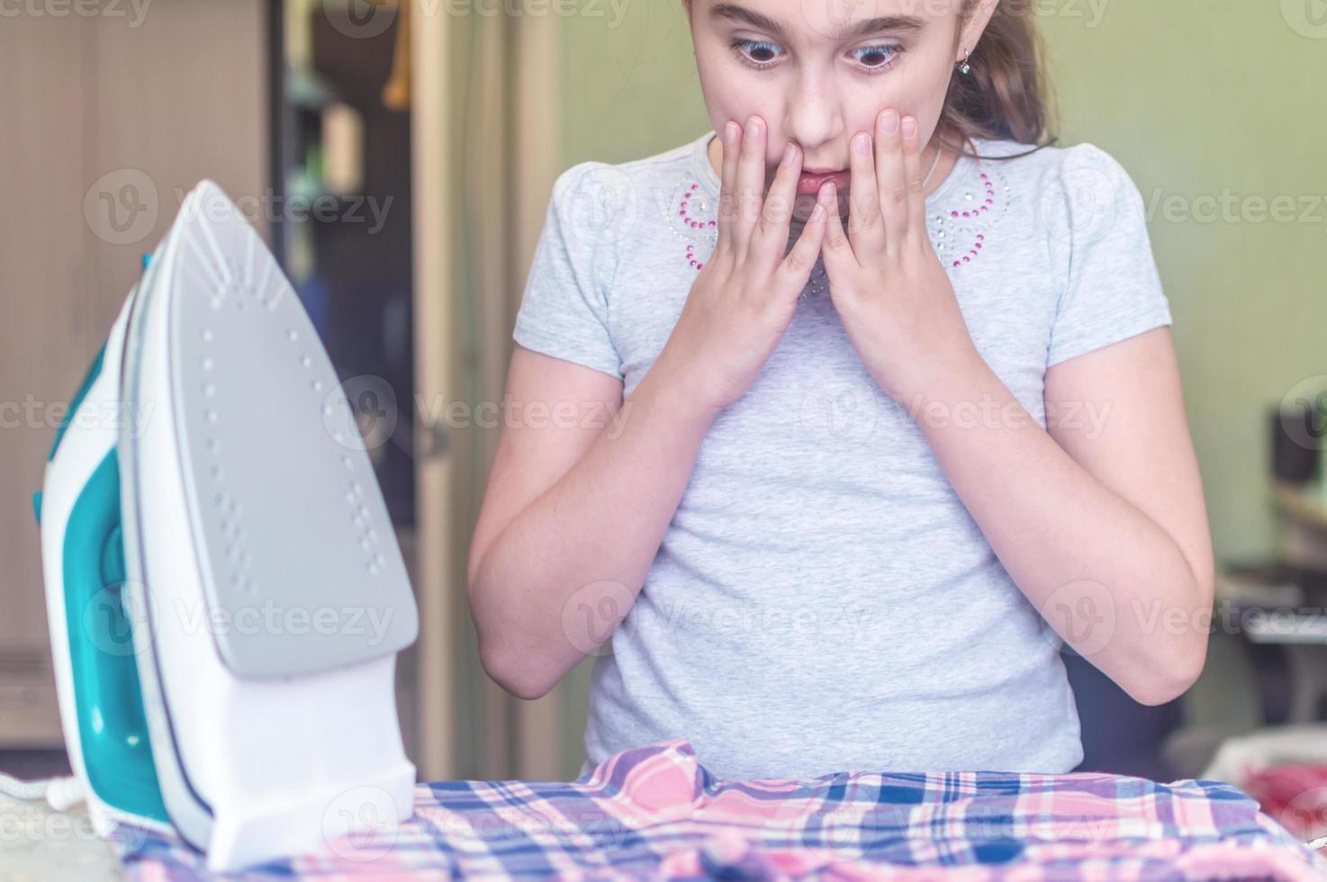 the girl burned clothes with an iron on the Ironing Board 4789306 Stock