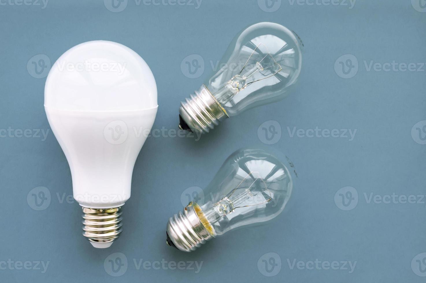 Energy-saving lamp with incandescent lamps on a gray background. The concept of saving energy. photo