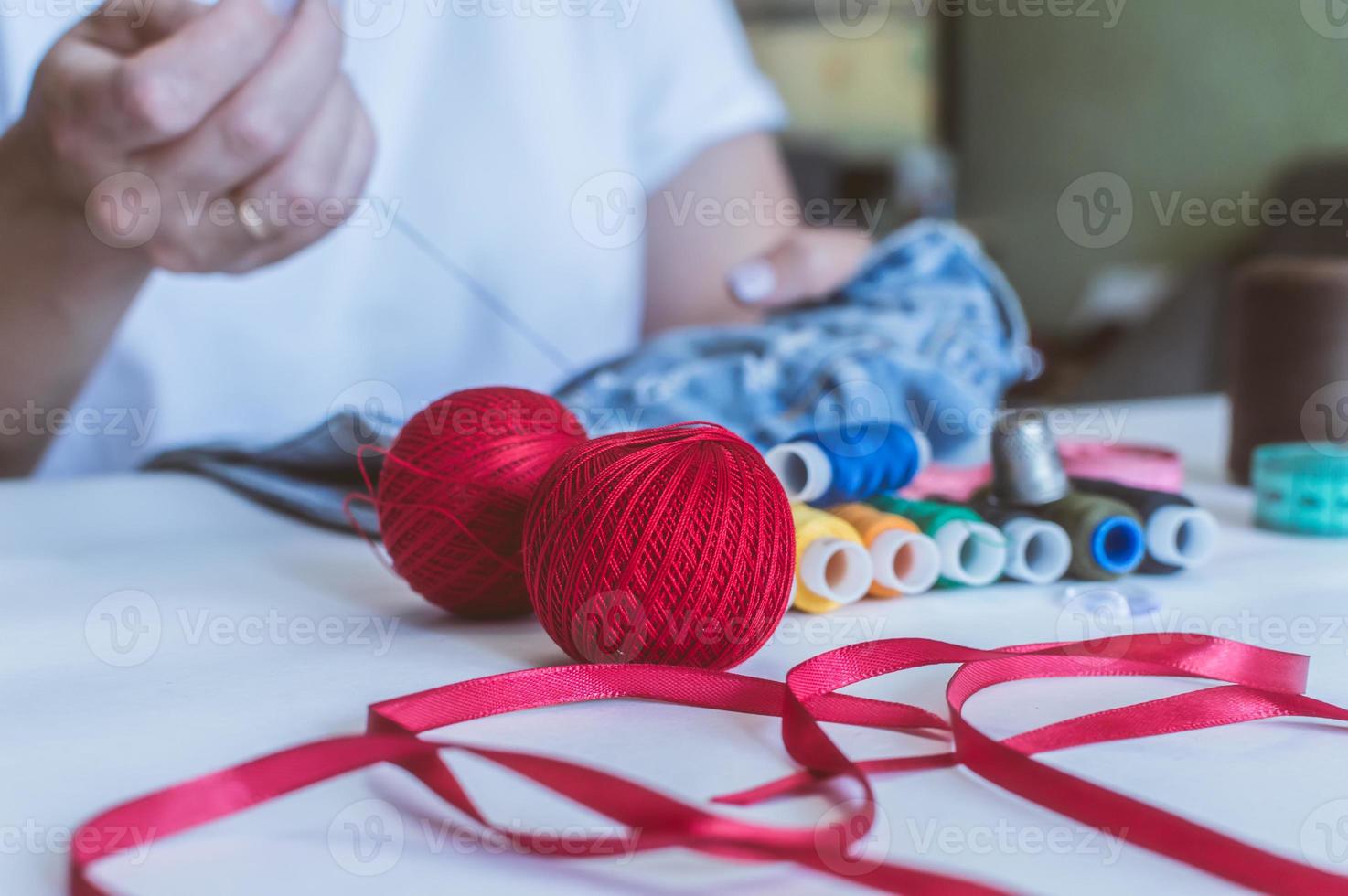 Female hands of designer at work with fabric close-up. Tailor