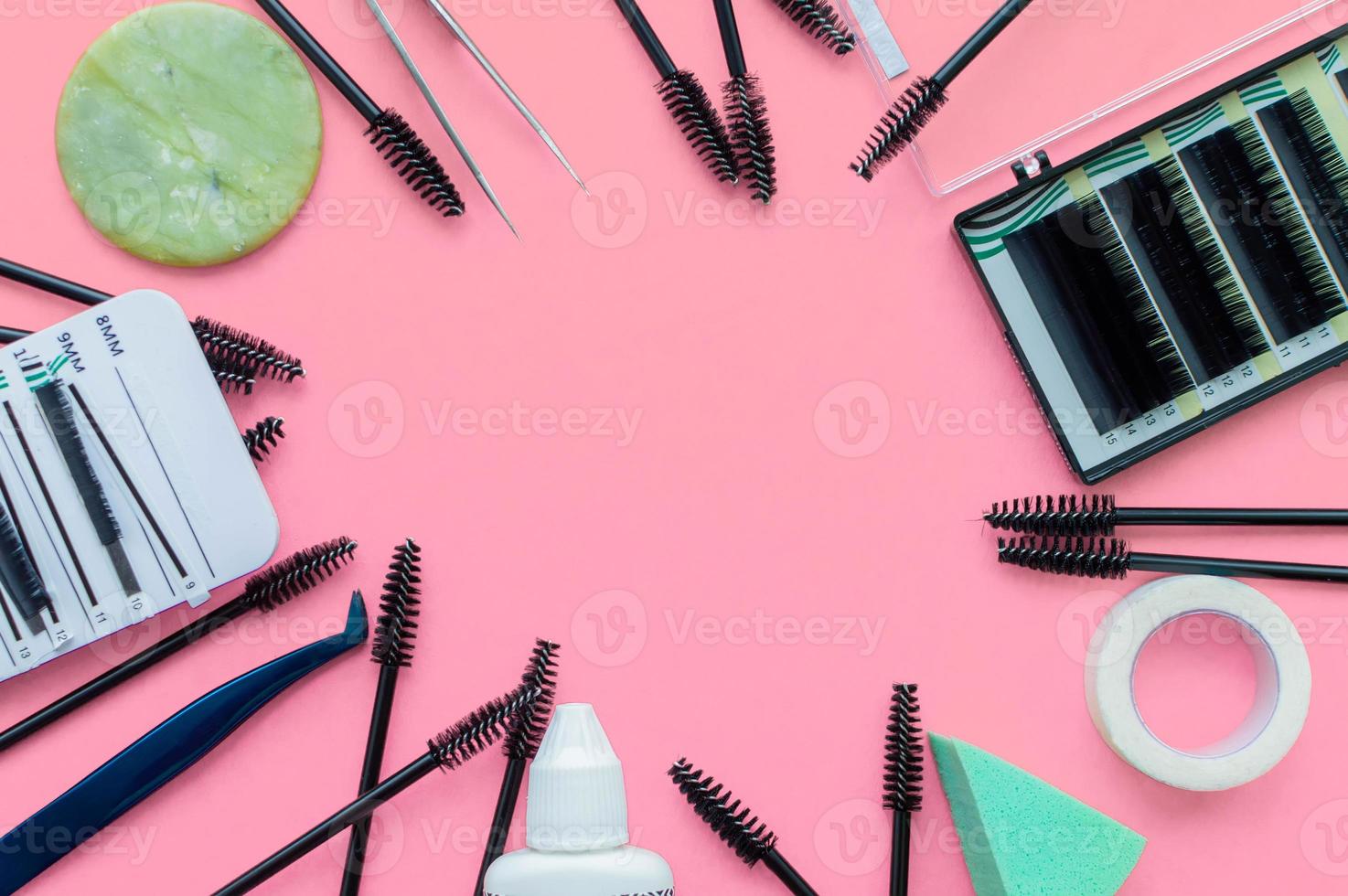 Template. Tools for eyelash extension on a pink background with a place for writing. photo