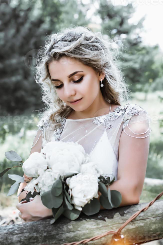 bride with a bouquet in her hands on the wedding day. wedding ceremony. selective focus. film grain. photo