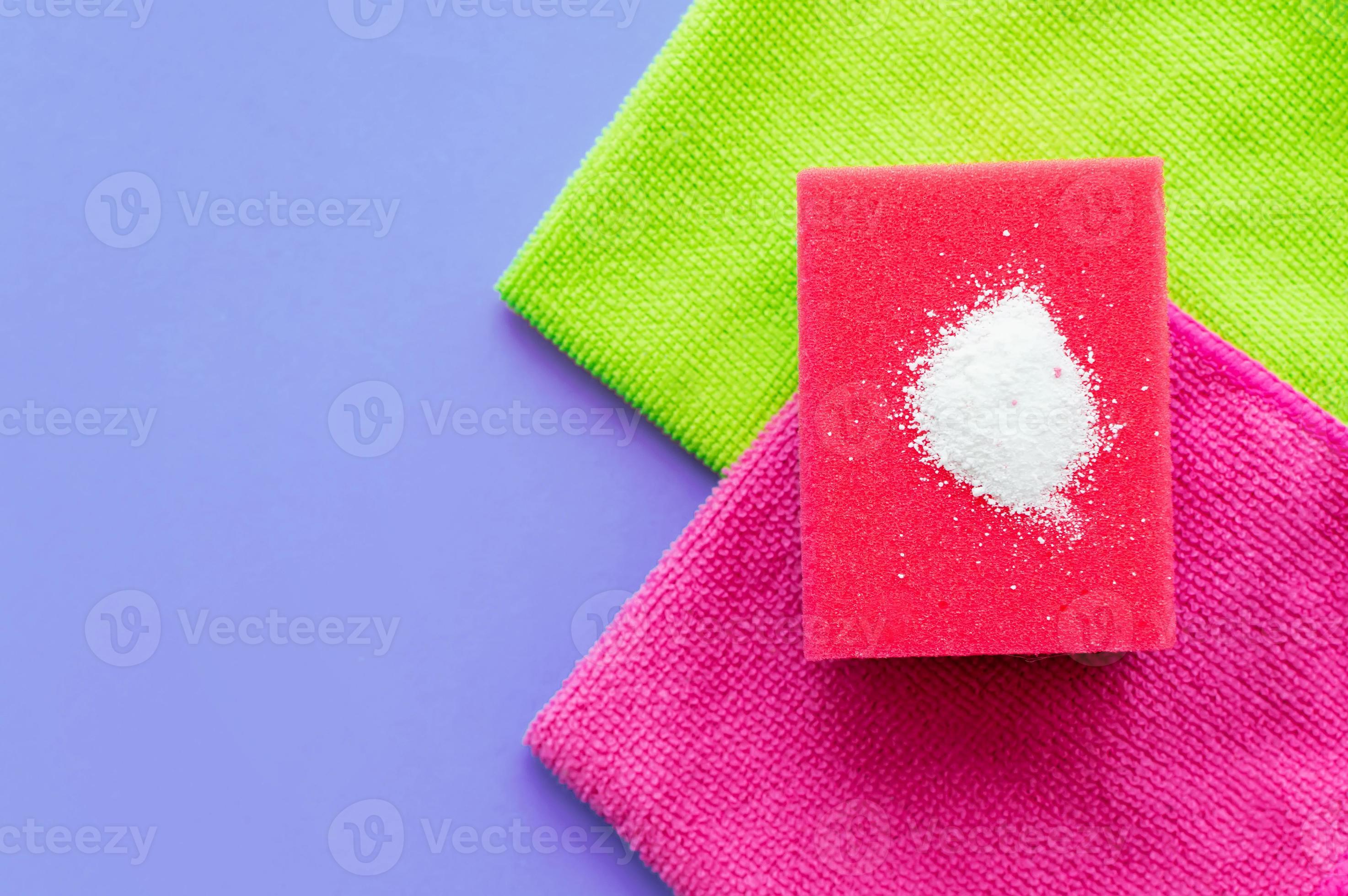 https://static.vecteezy.com/system/resources/previews/004/790/163/large_2x/cleaning-powder-on-a-red-sponge-for-washing-dishes-on-a-household-towel-on-a-lilac-background-the-concept-of-homework-photo.jpg