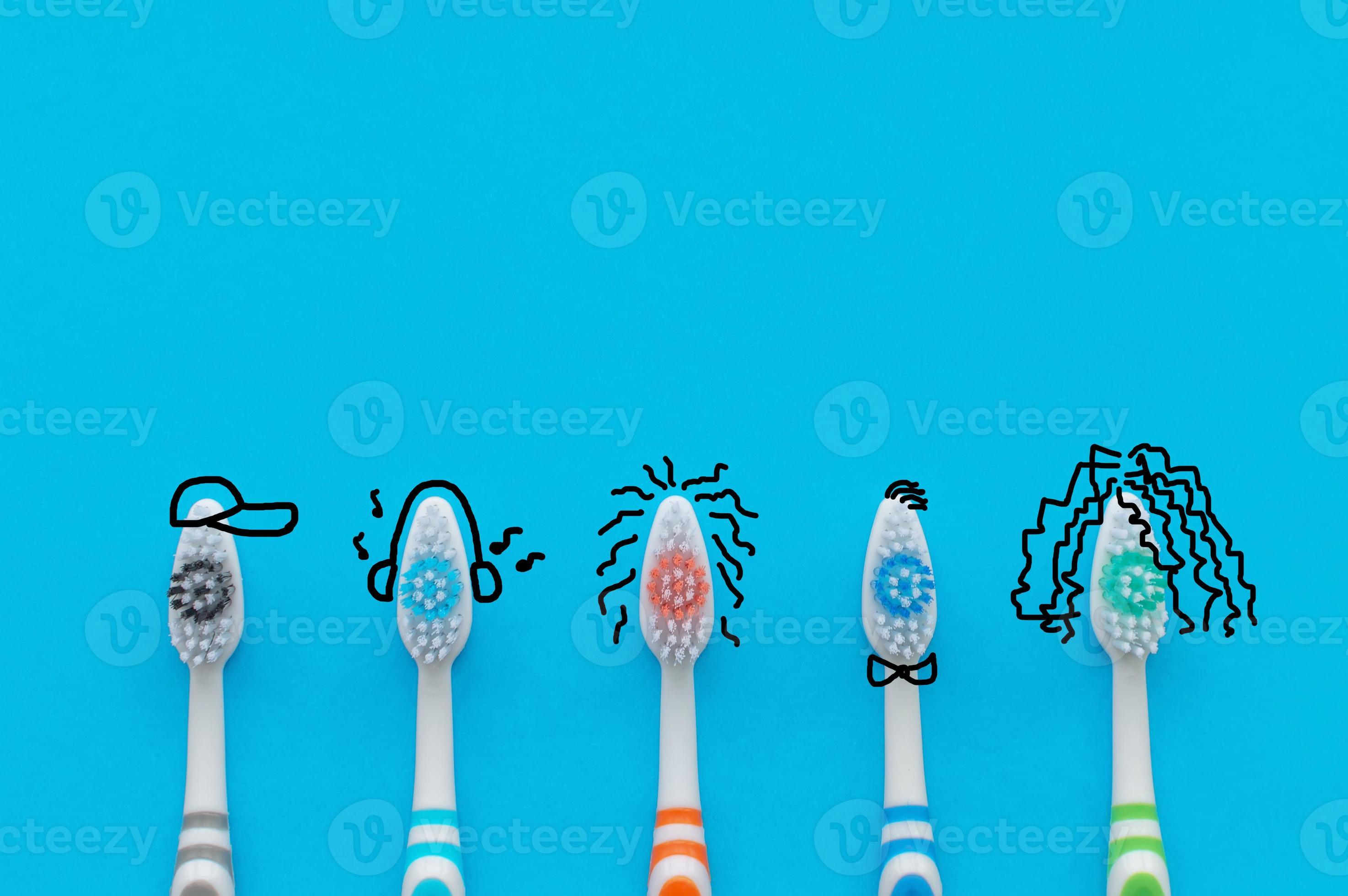 Colorful toothbrushes on a blue background in the form of cartoon ...