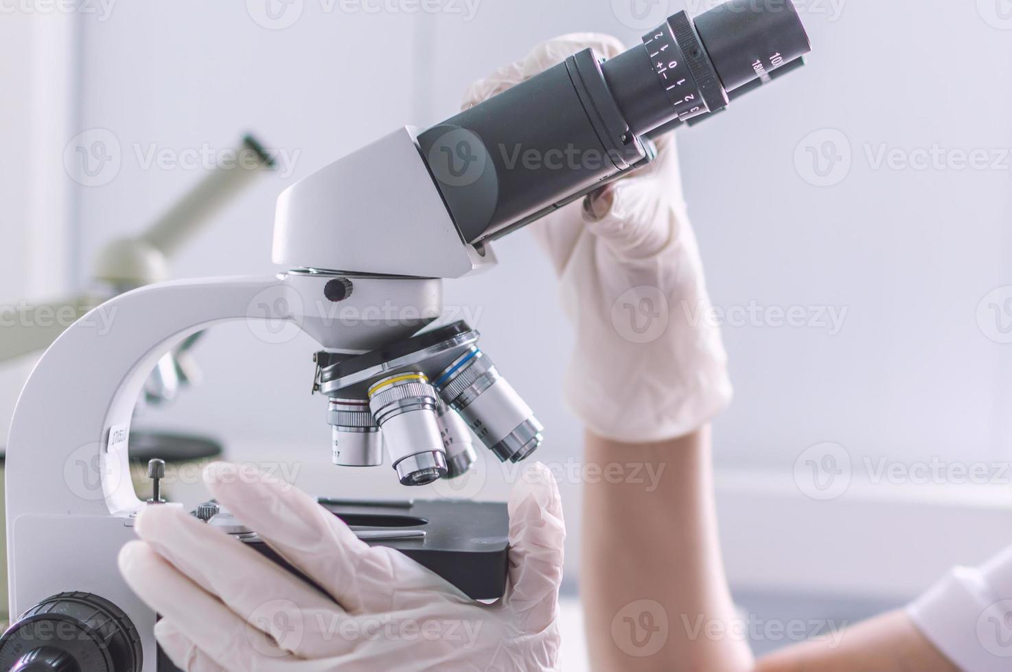 Hands with microscope in the laboratory photo