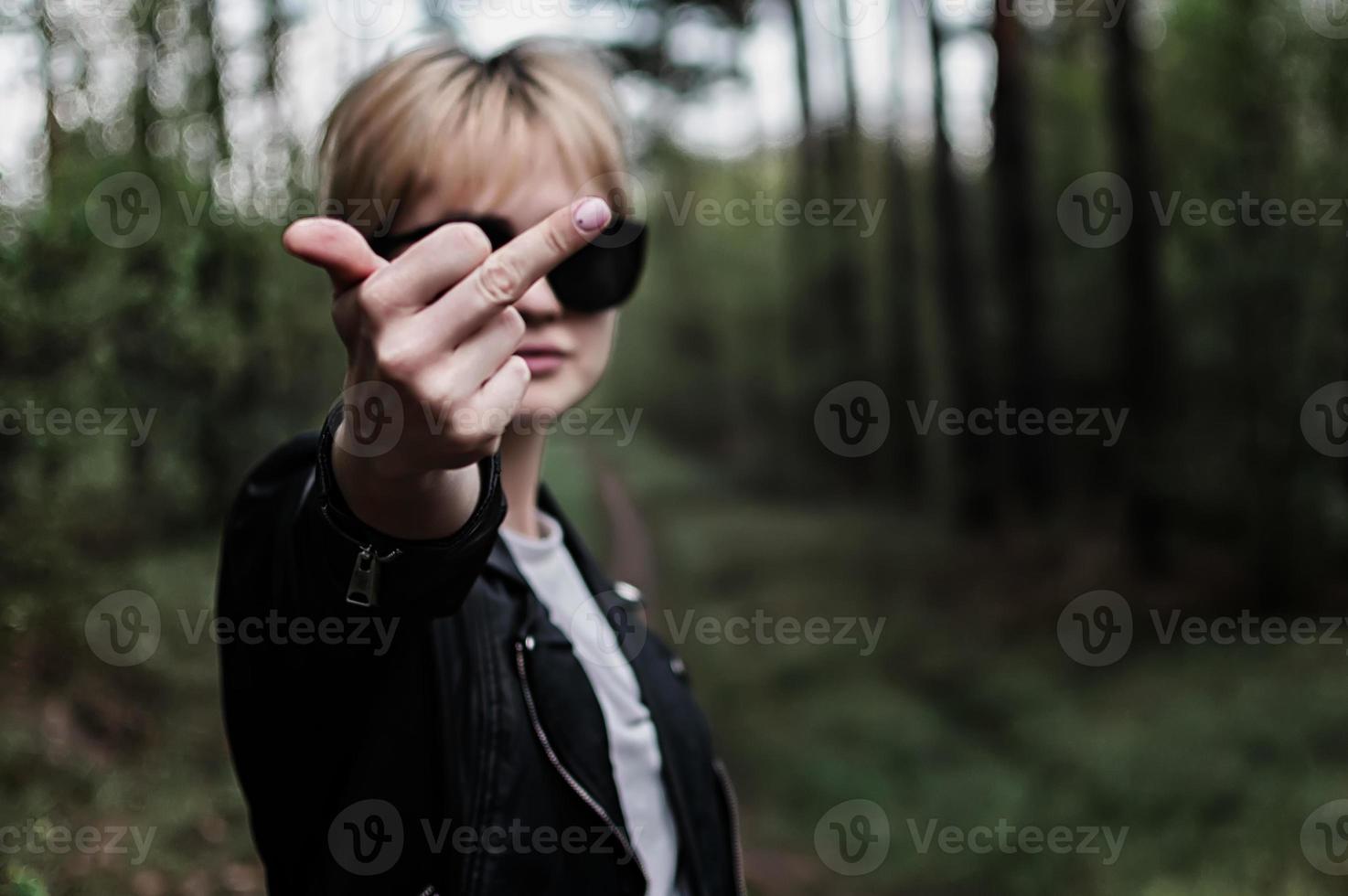 girl in sunglasses in the forest photo