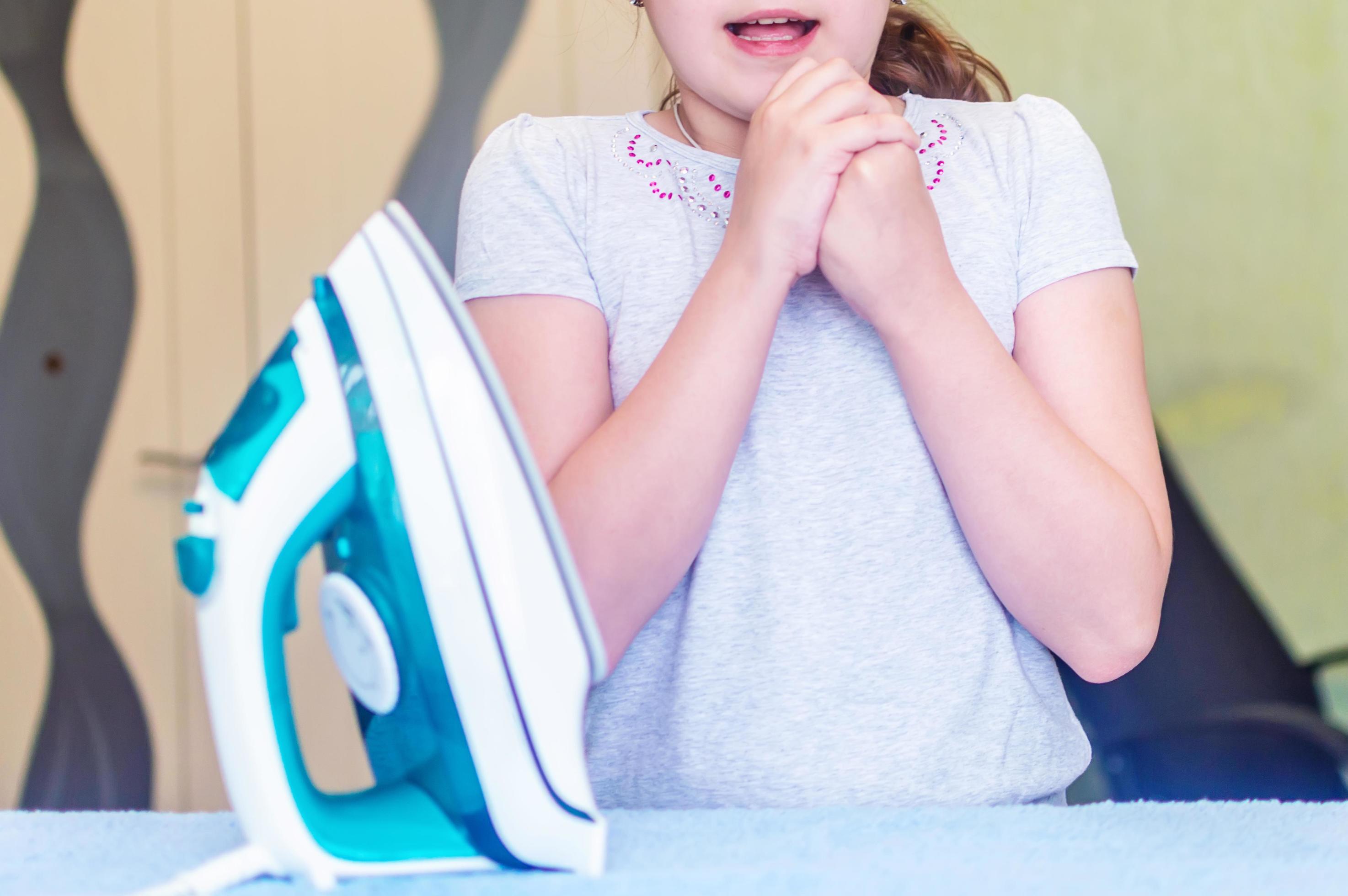 the girl received a burn when Ironing clothes on the Ironing Board with