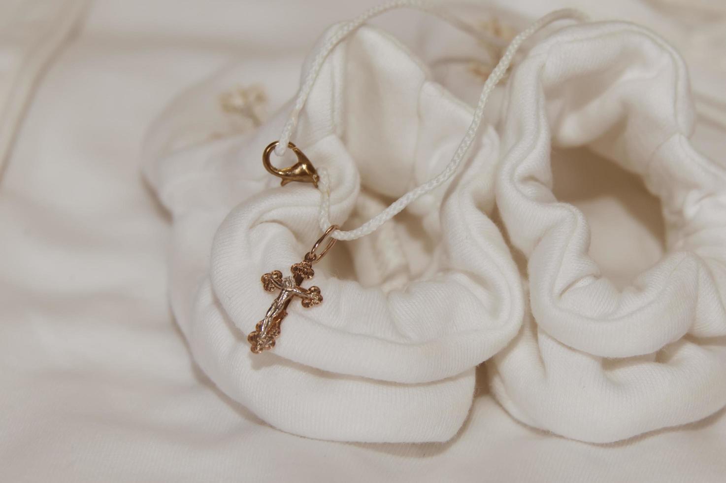 Baby booties in the church at the baptism. Religion. Close-up. photo