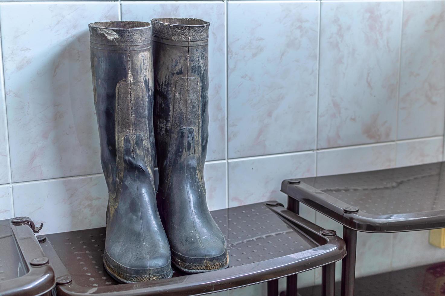 dirty rubber boots on the chair photo