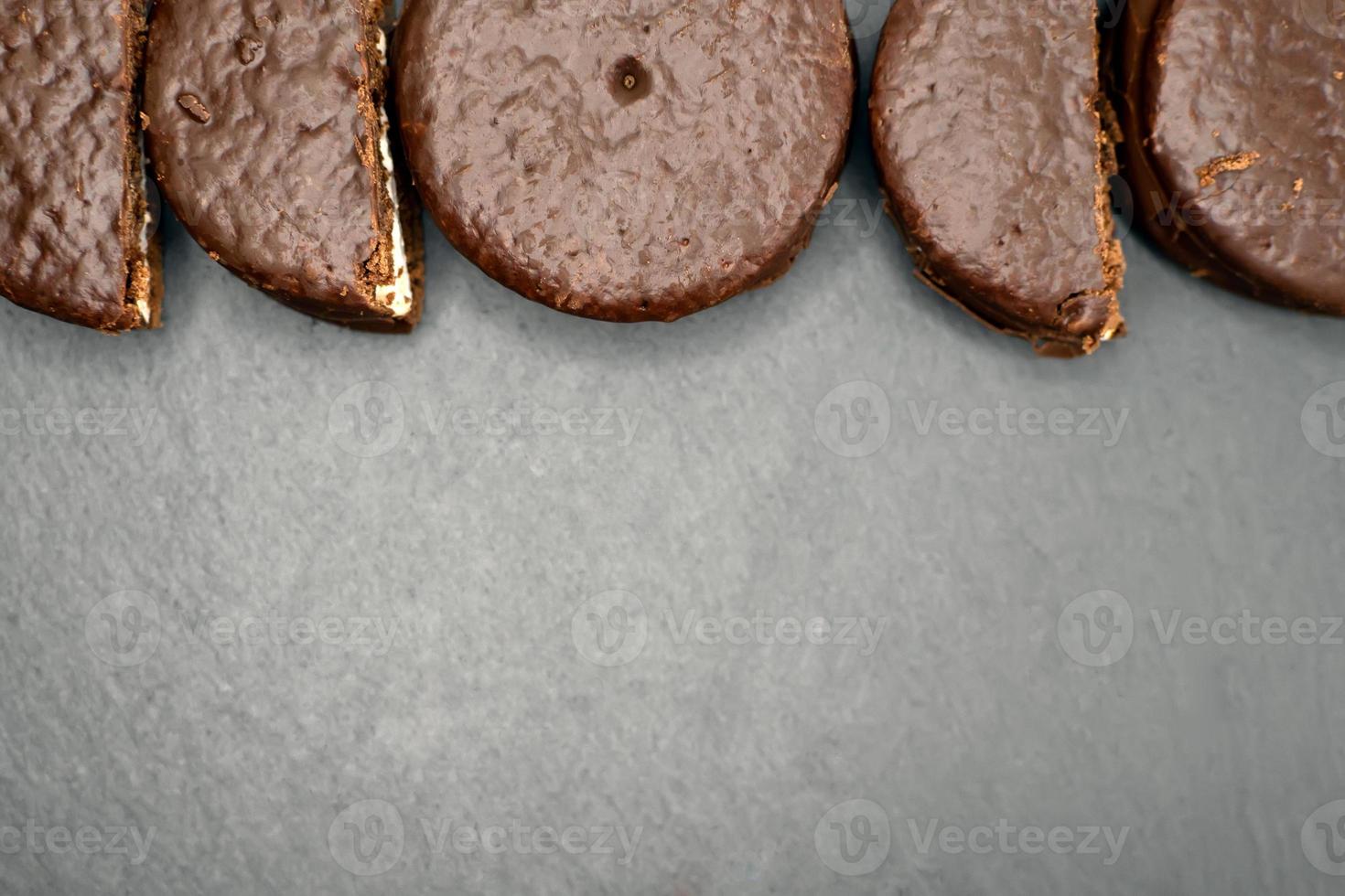 Cookies in chocolate glaze on a dark background. Top view. photo