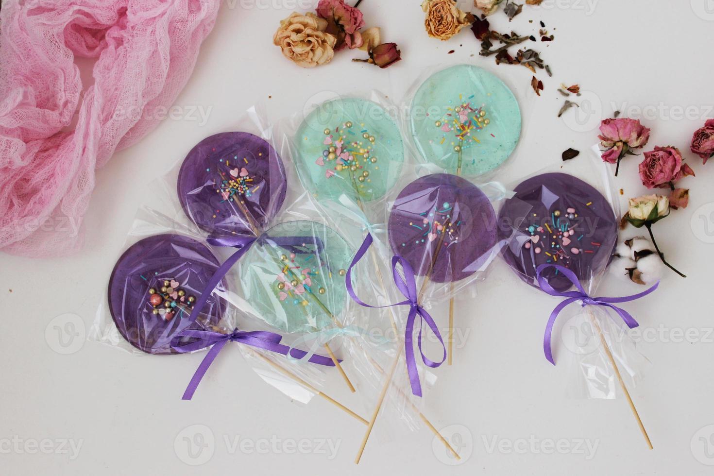 Colorful lollipops on a stick on the table. Decoration of the festive table. Work at home. Horizontal photo. photo