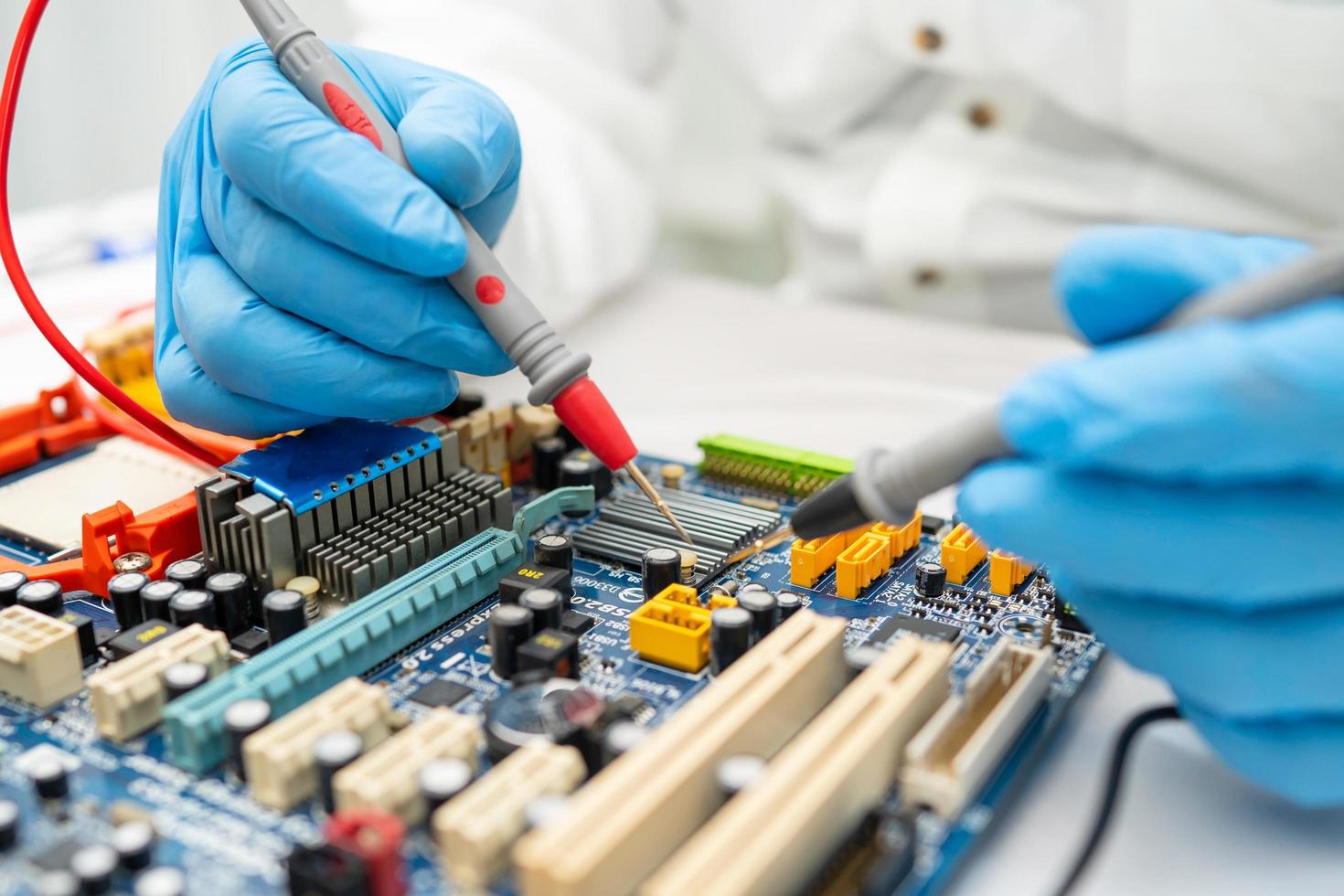 technician repairing inside of hard disk by soldering iron. Integrated Circuit. the concept of data, hardware, technician and technology. photo