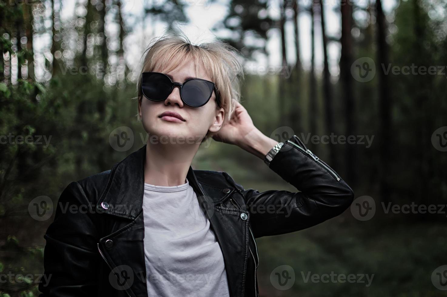 girl in sunglasses in the forest photo
