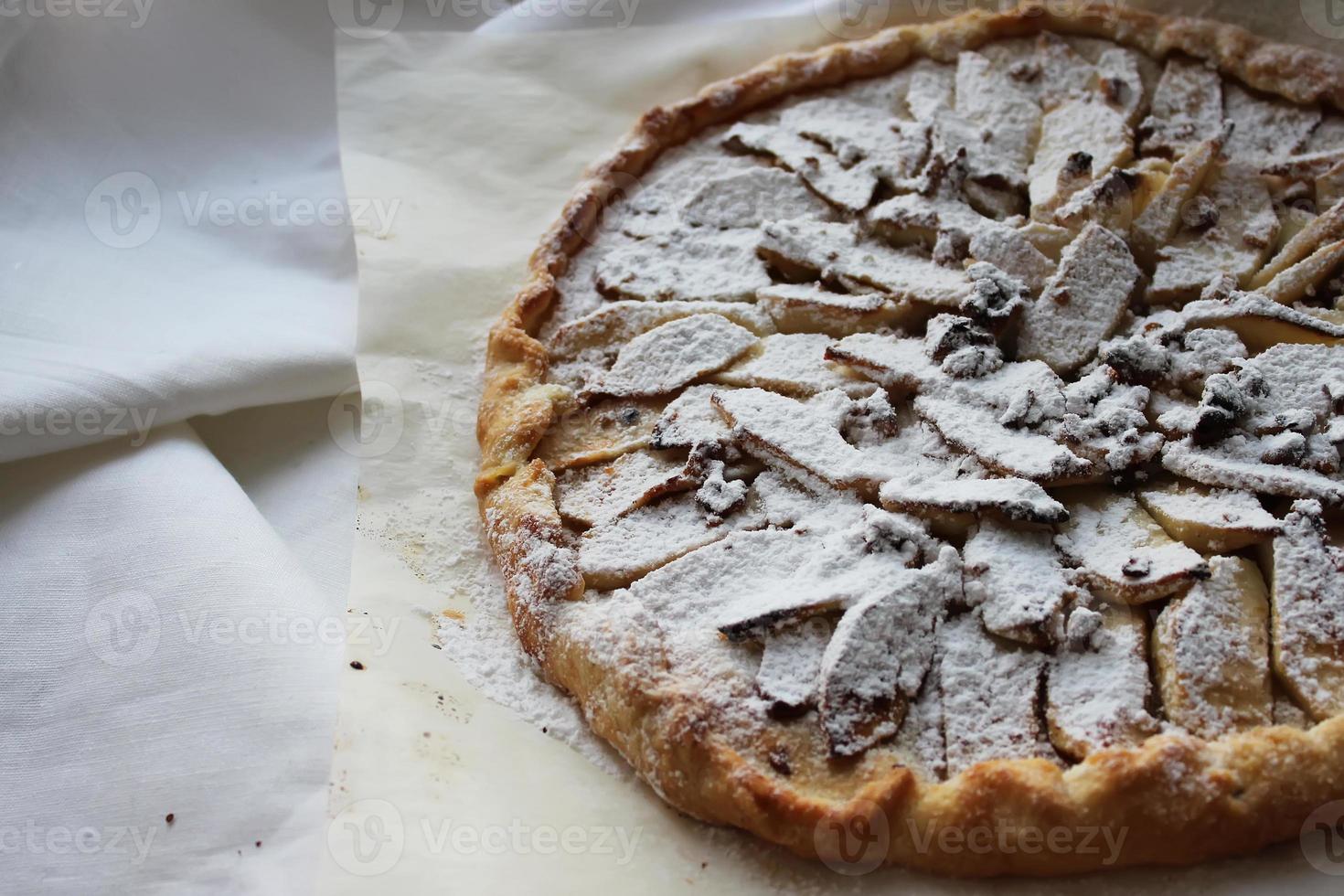 Apple pie sprinkled with powdered sugar. Homemade cake. Housework. photo