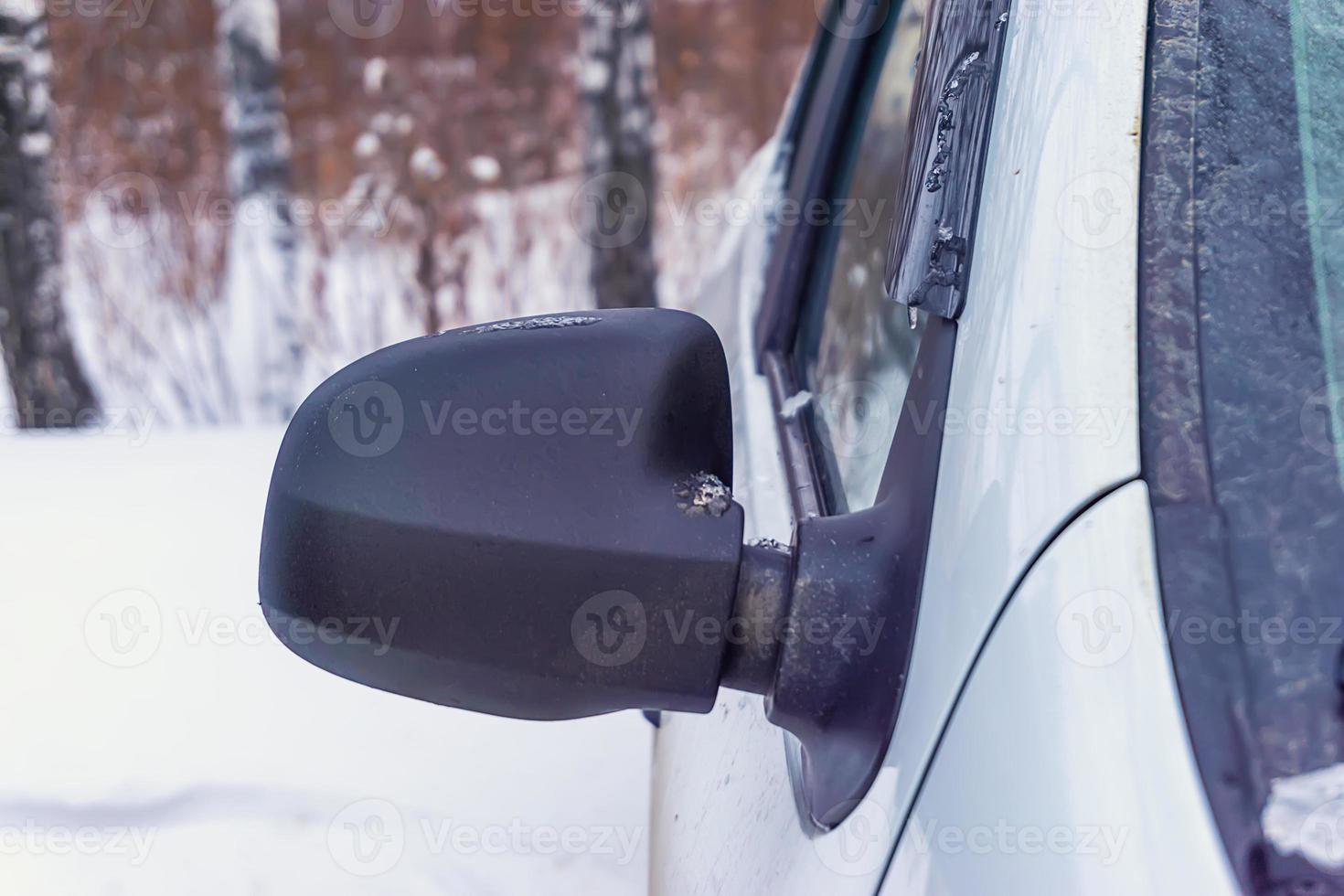 dirty automobile mirror in the winter photo