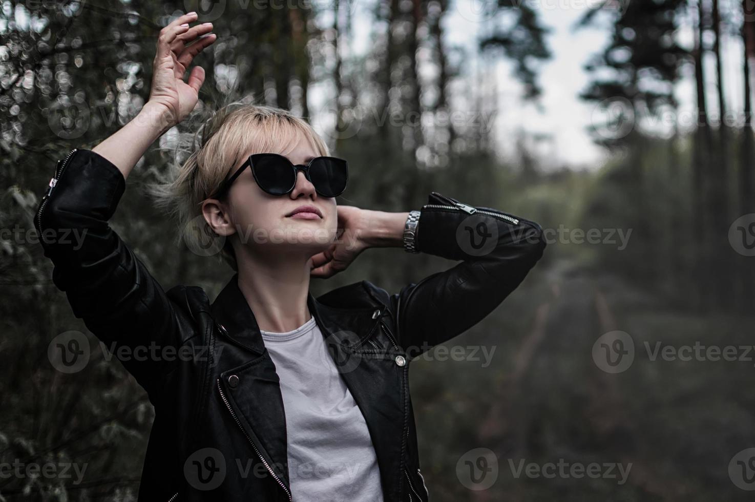 girl in sunglasses in the forest photo