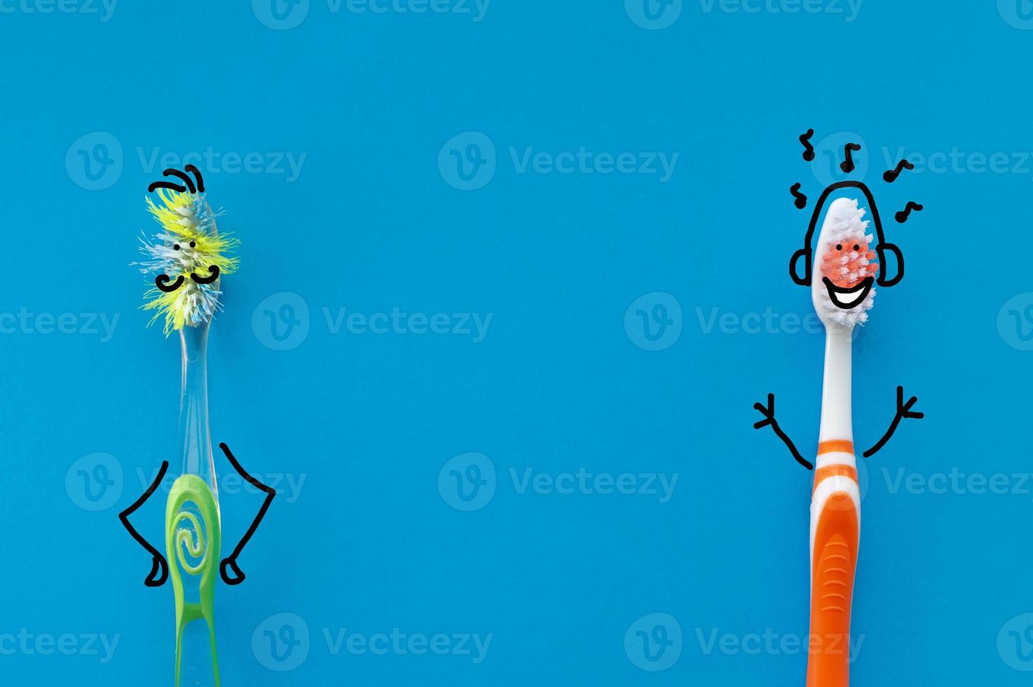 New and old toothbrush in the form of cartoon characters on a blue background. The view from the top. The concept of dental health. photo