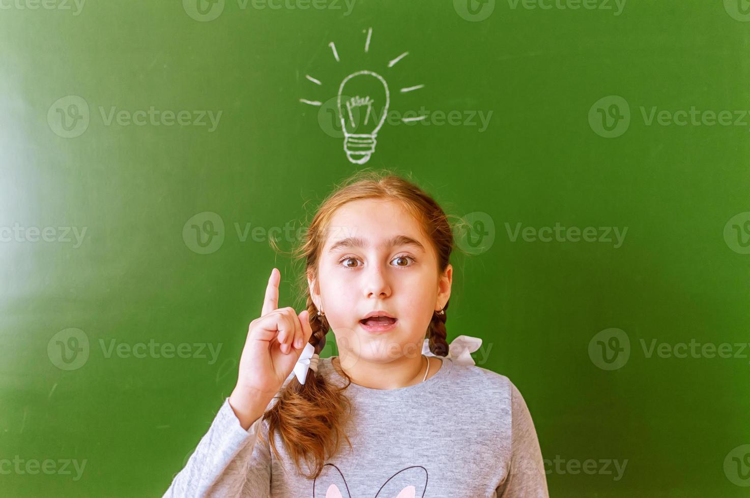 A schoolgirl at the blackboard was able to find a solution to the problem. inspiration. the idea came photo