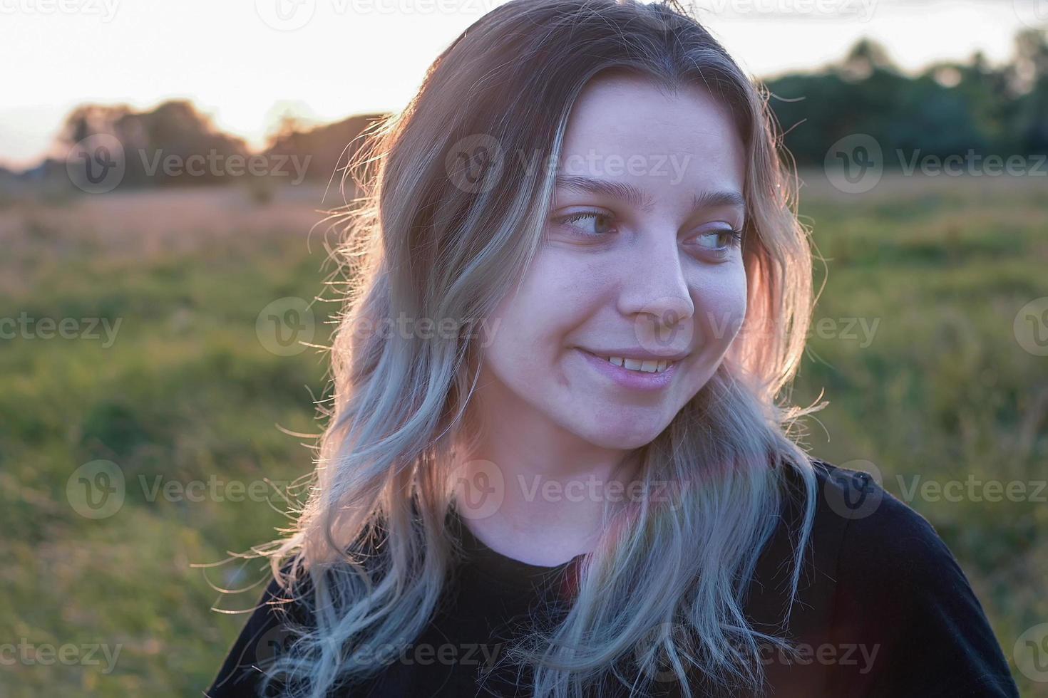 portrait of a beautiful European girl with loose hair against the background of nature photo