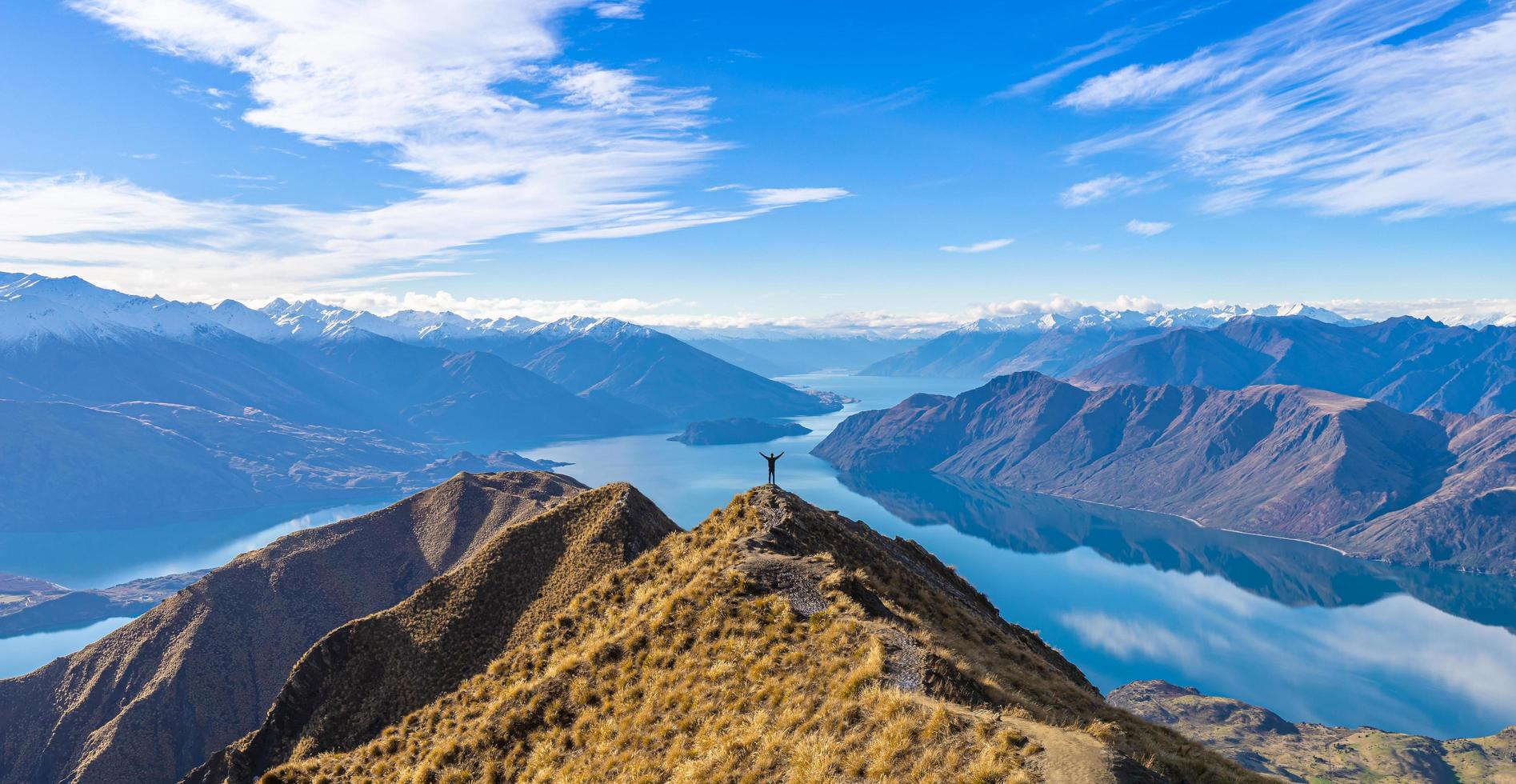 Asian traveler celebrating success at Roy's Peak Lake Wanaka New Zealand photo