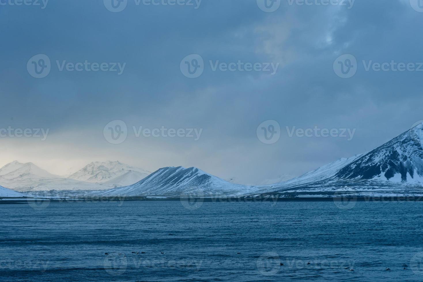 beautiful sea winter ambiance with large blue sky in he sky surface hills. photo