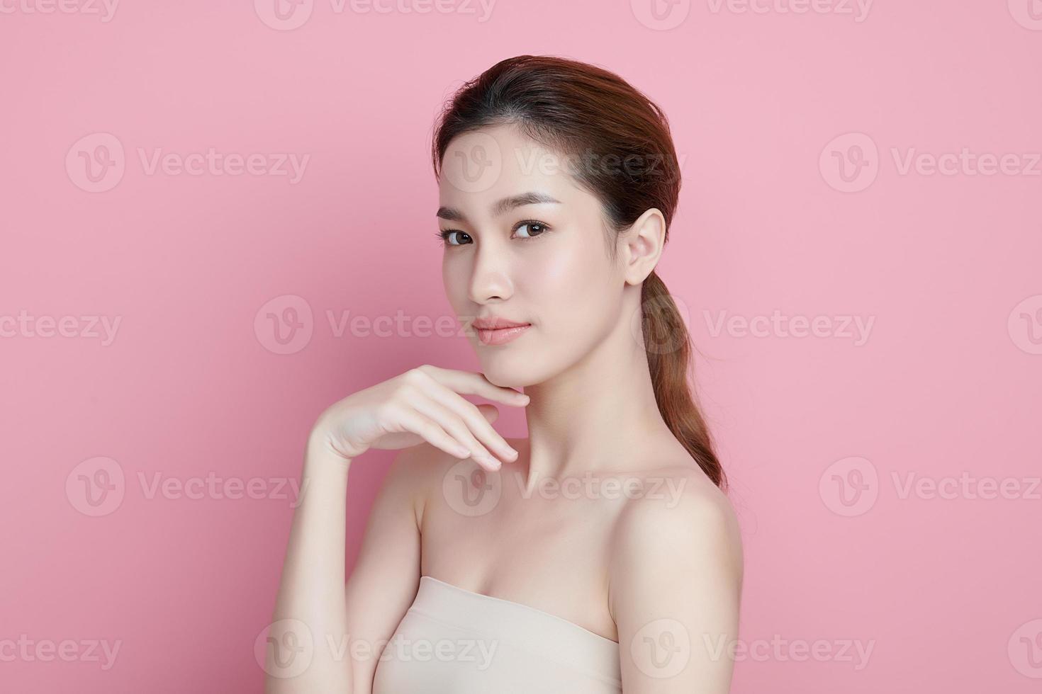 Beautiful young asian woman with clean fresh skin on pink background, Face care, Facial treatment, Cosmetology, beauty and spa, Asian women portrait. photo