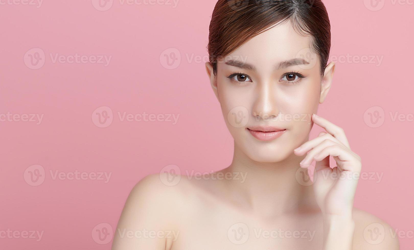 Beautiful young asian woman with clean fresh skin on pink background, Face care, Facial treatment, Cosmetology, beauty and spa, Asian women portrait. photo