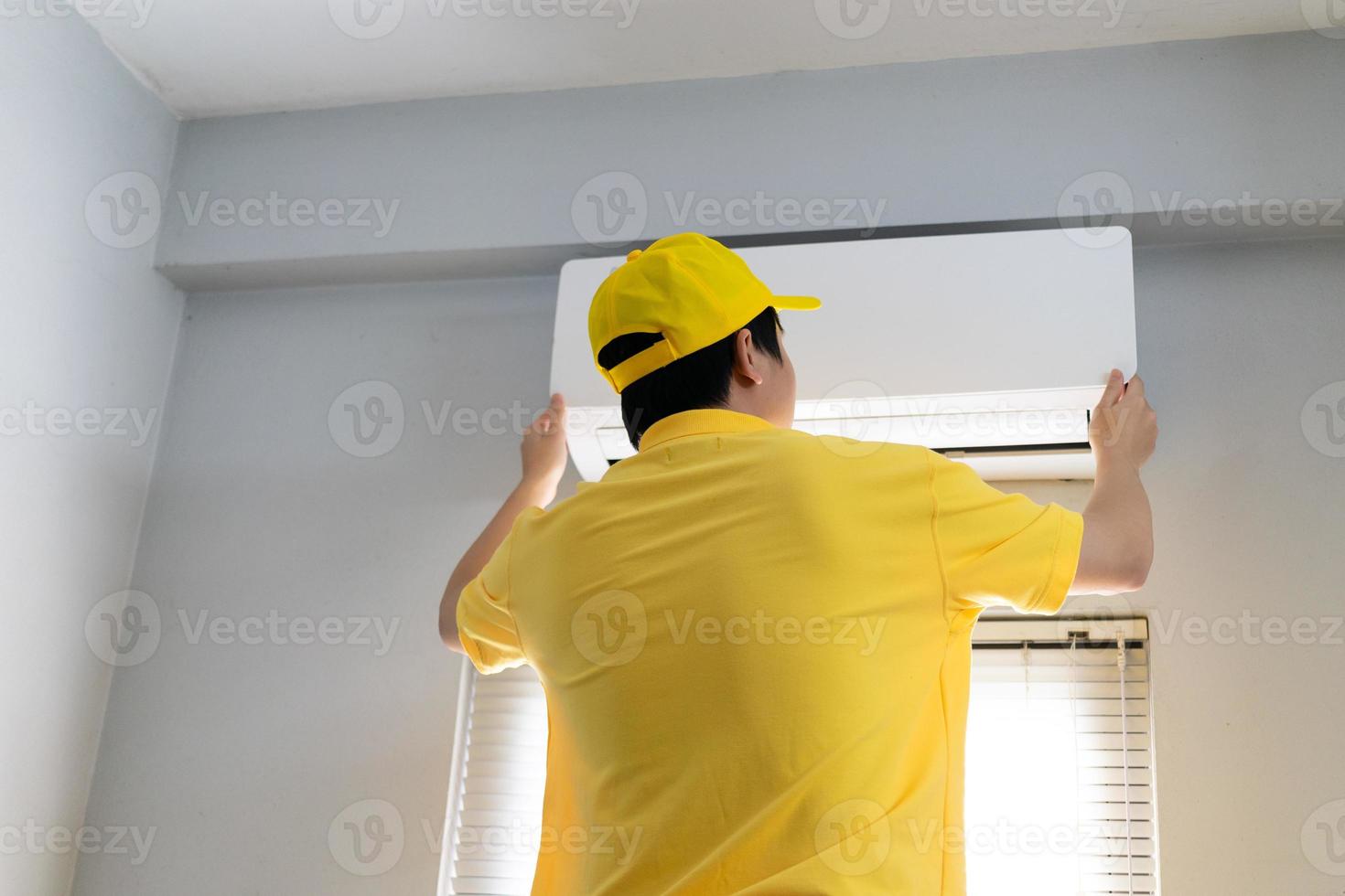 Repairmen are periodically repairing and cleaning the air conditioner photo