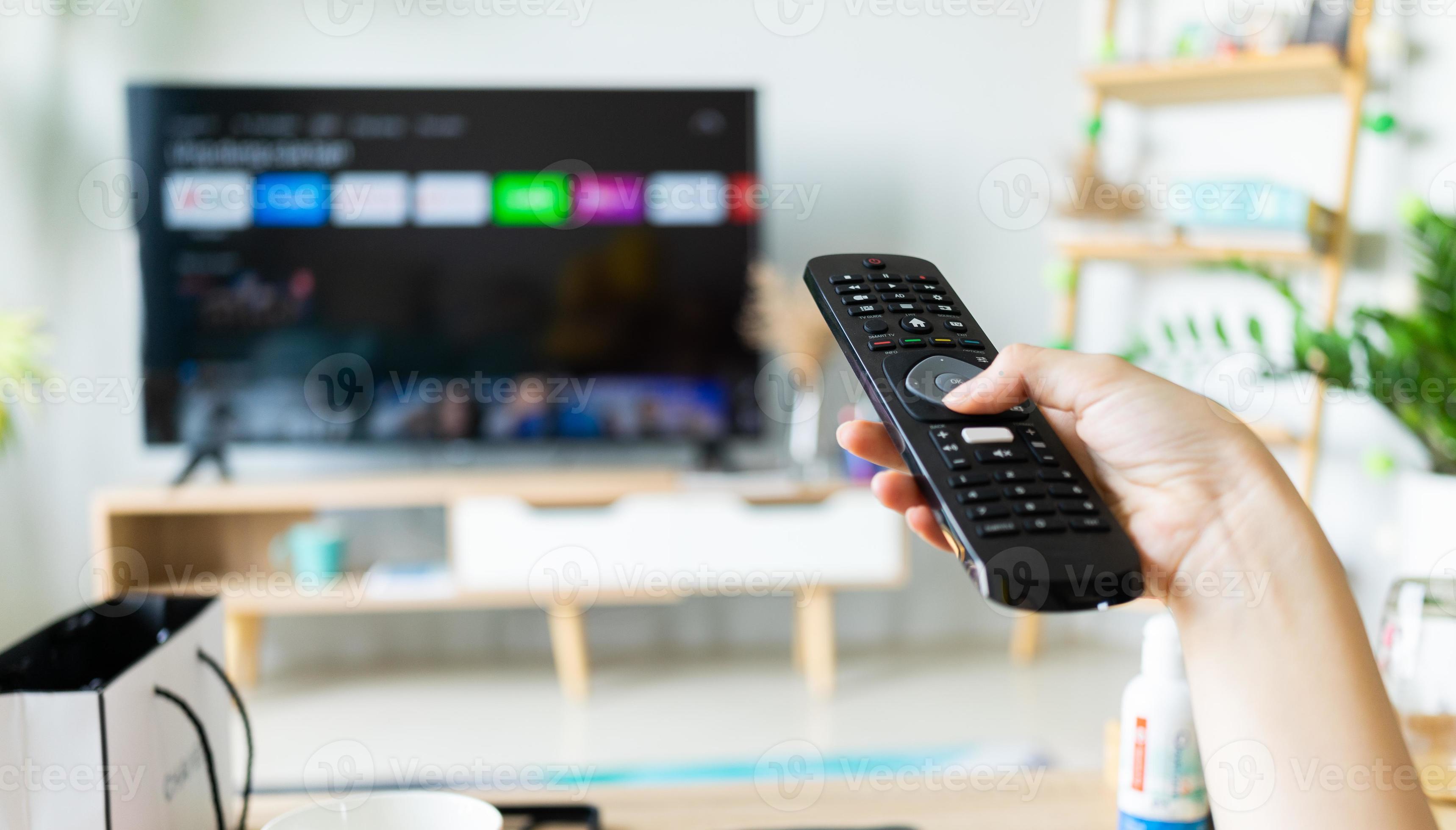 Asian woman holding tv remote in hand to change channel 4797654 Stock