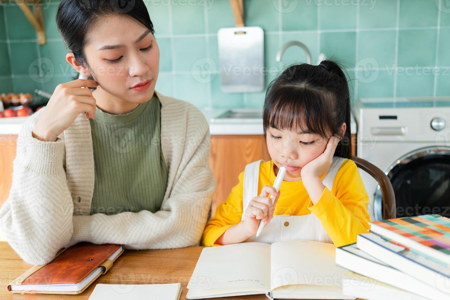 Asian Mother and daughter studying together at home photo
