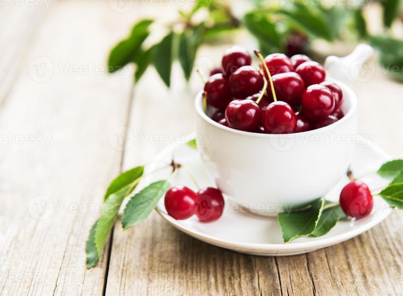 Cup with cherries photo