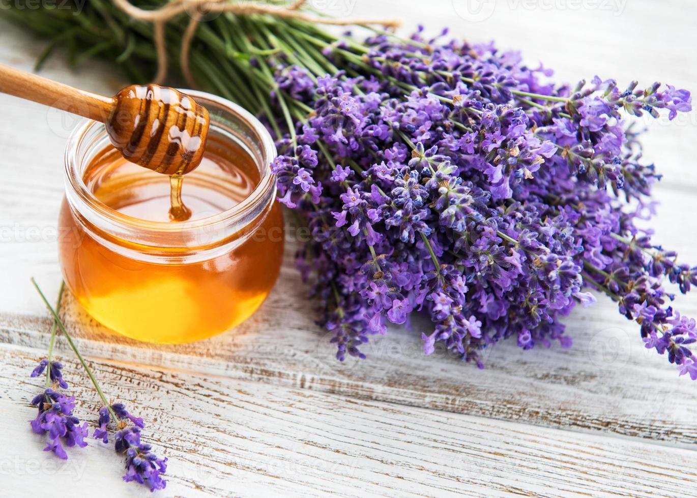 Jar with honey and fresh lavender photo