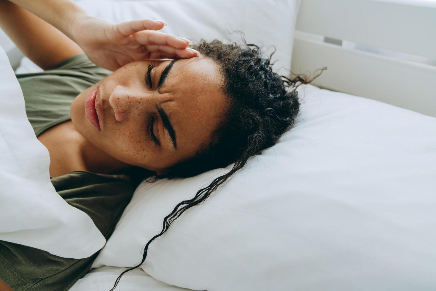 Displeased African woman suffering from headache photo