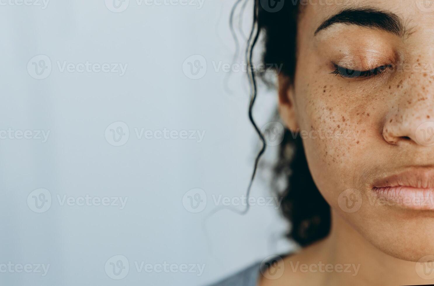 Black woman posing with eyes closed during spending time at home photo