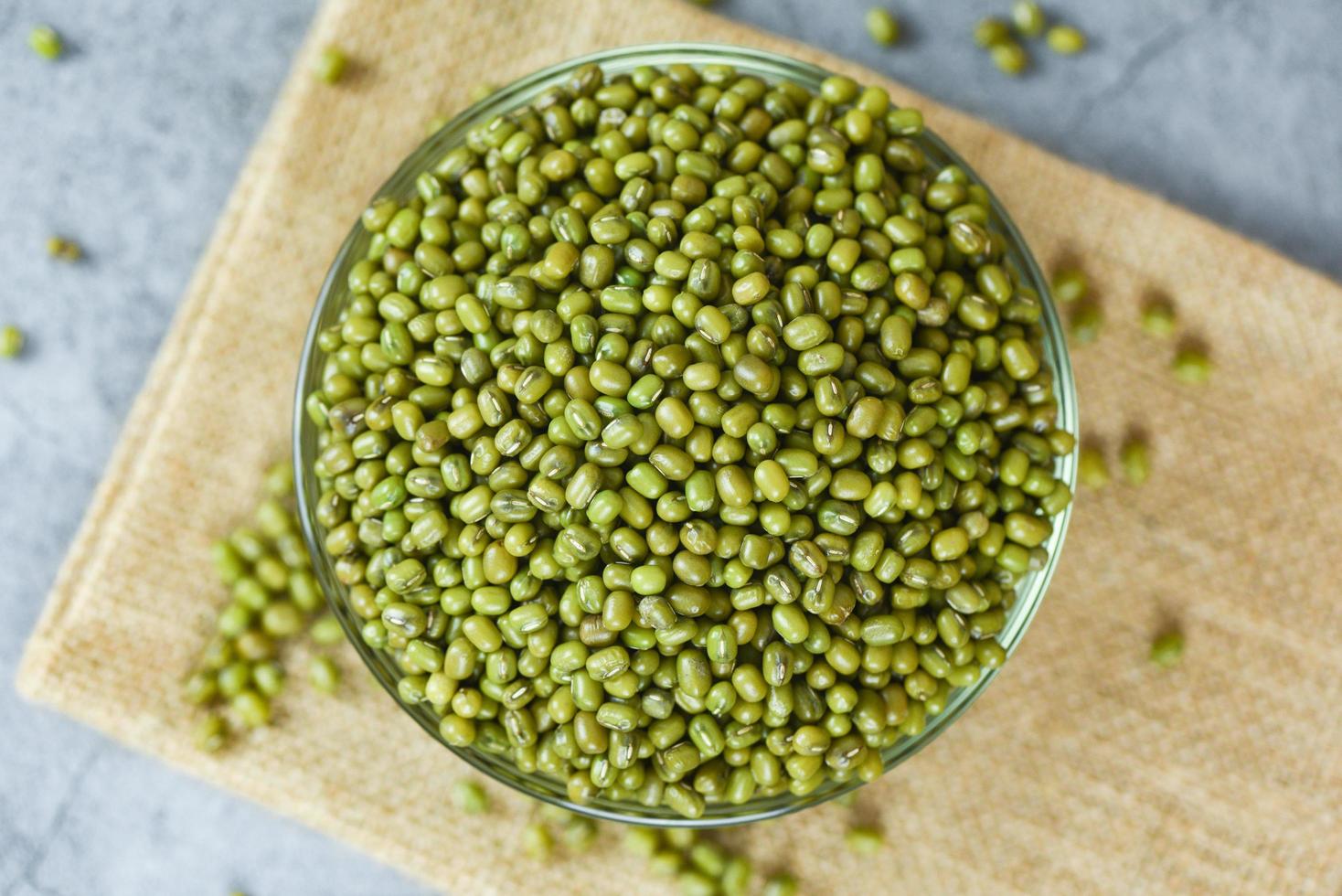 Green mung beans in bowl on gray background - Mung bean seed cereal whole grains photo