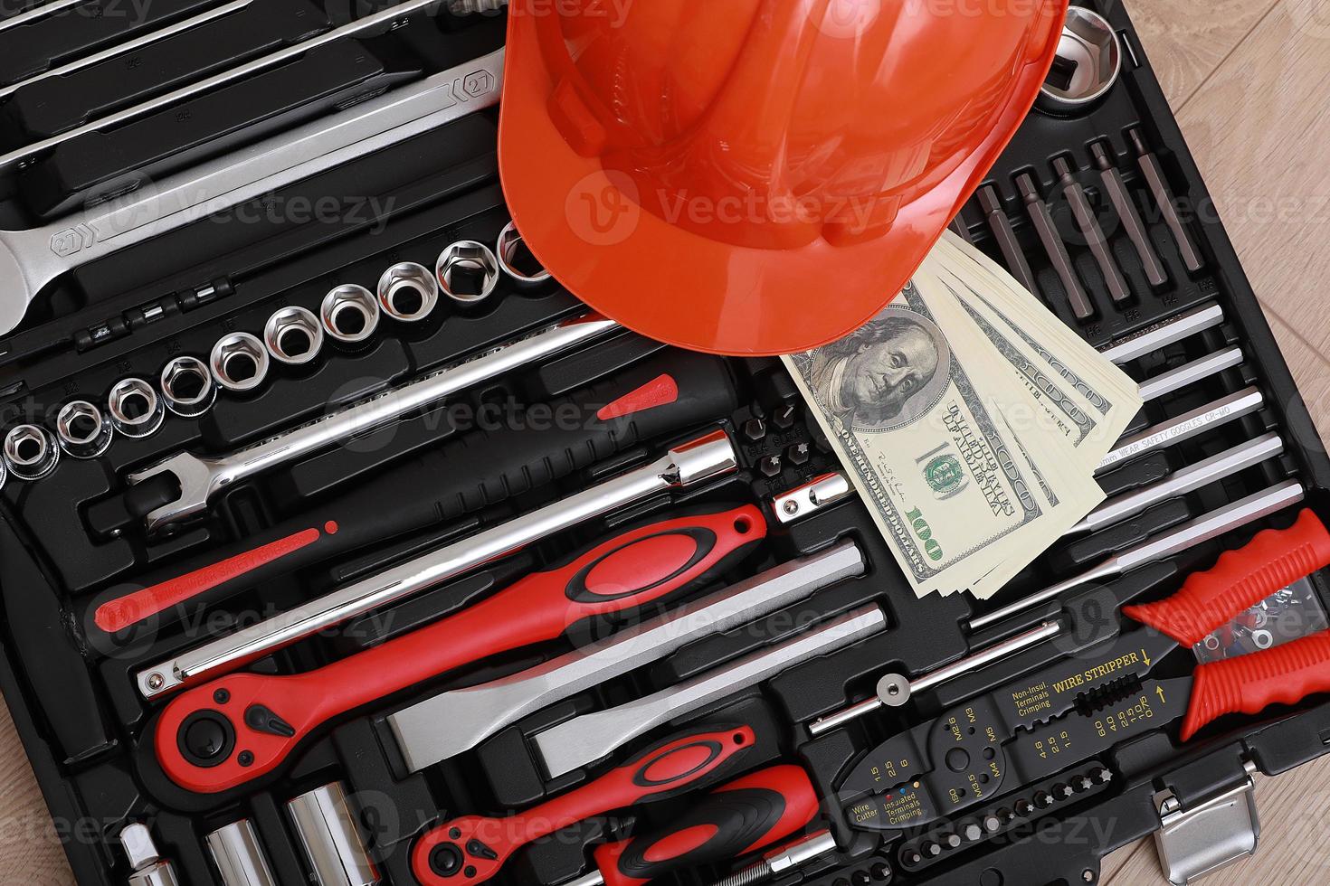 Toolbox, tools kit detail, dollar bills and orange protective helmet close up. instruments. set of tools. car tool kit. tool set background. instruments for repair. money for repairs photo