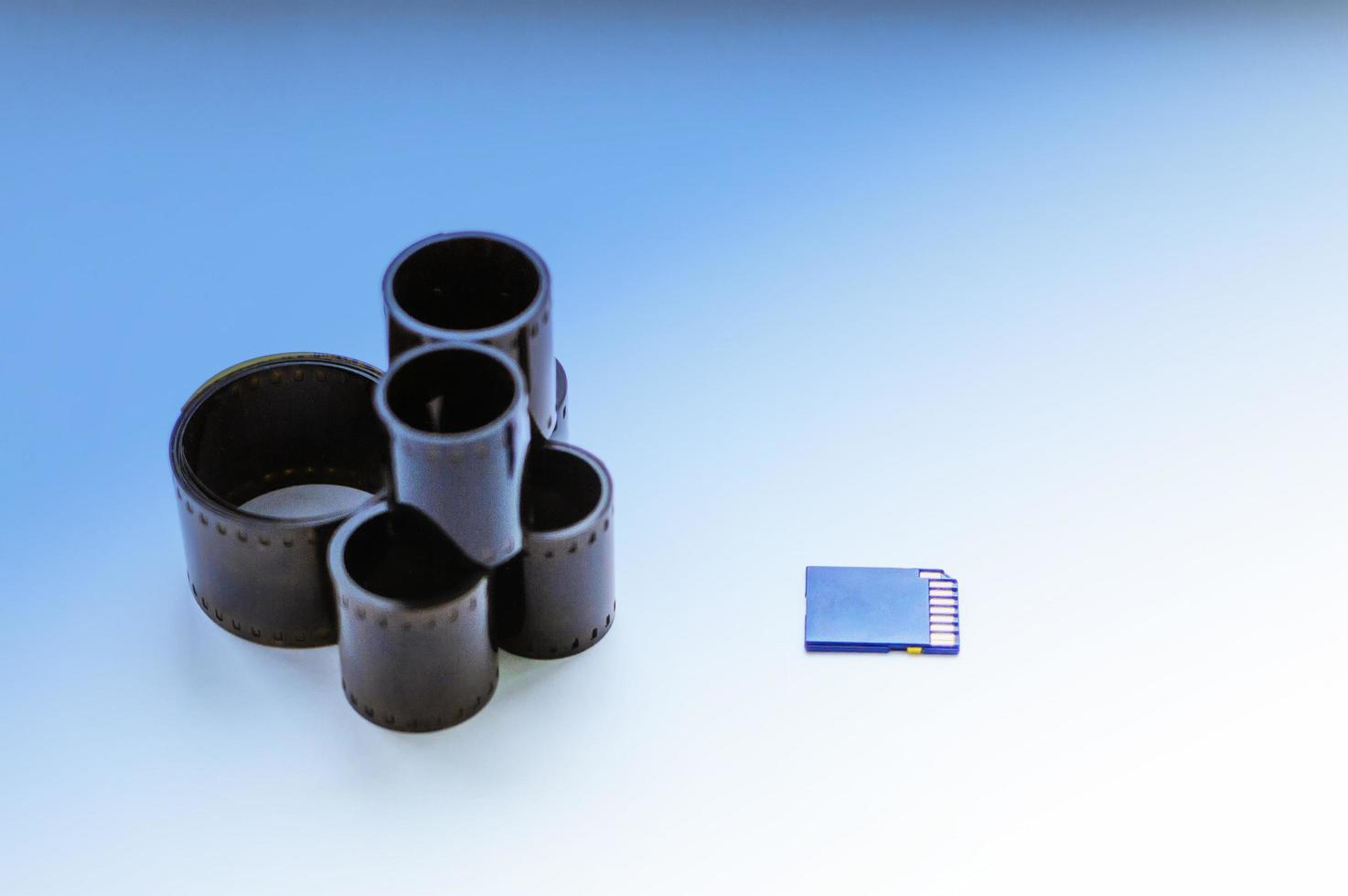 film and flash card on a white background. Concept of progress and development of technologies. Selective focus, film grain. photo
