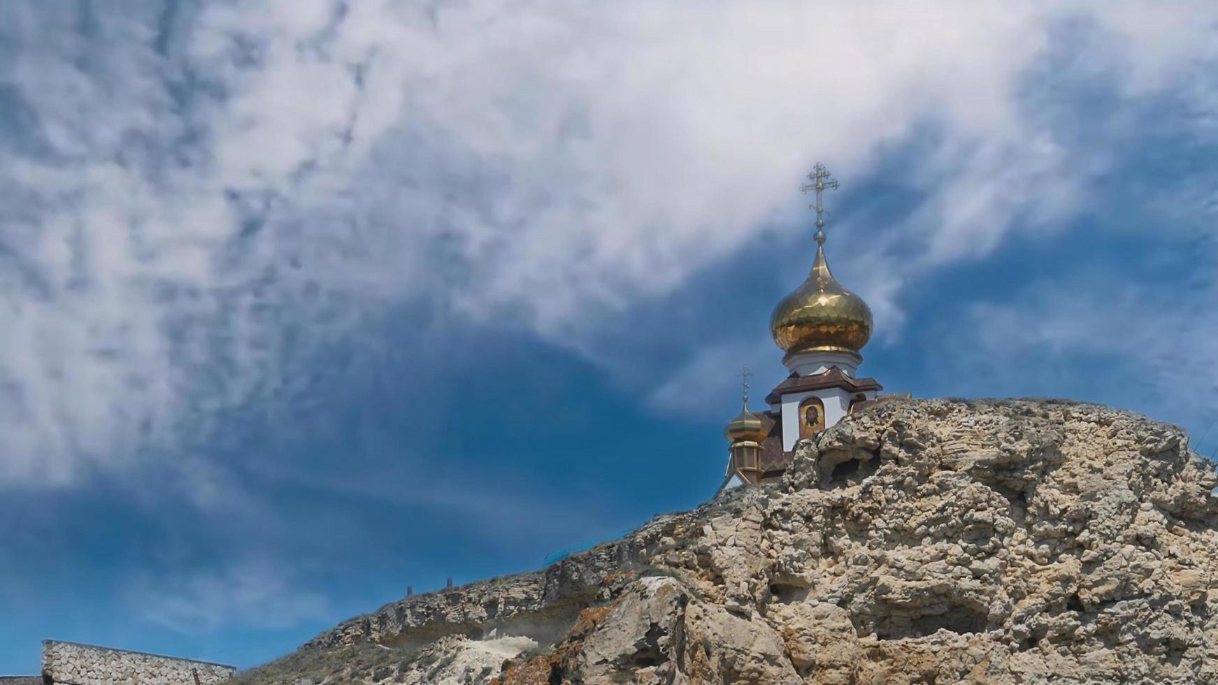 Cinemagraph of a landscape with a Christian chapel on a rock. photo