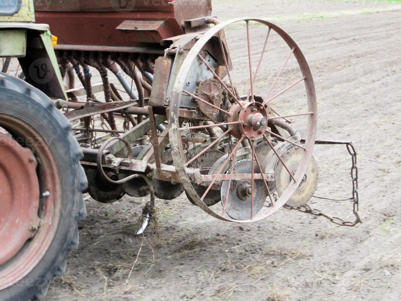 Plowed field by tractor in brown soil on open countryside nature photo