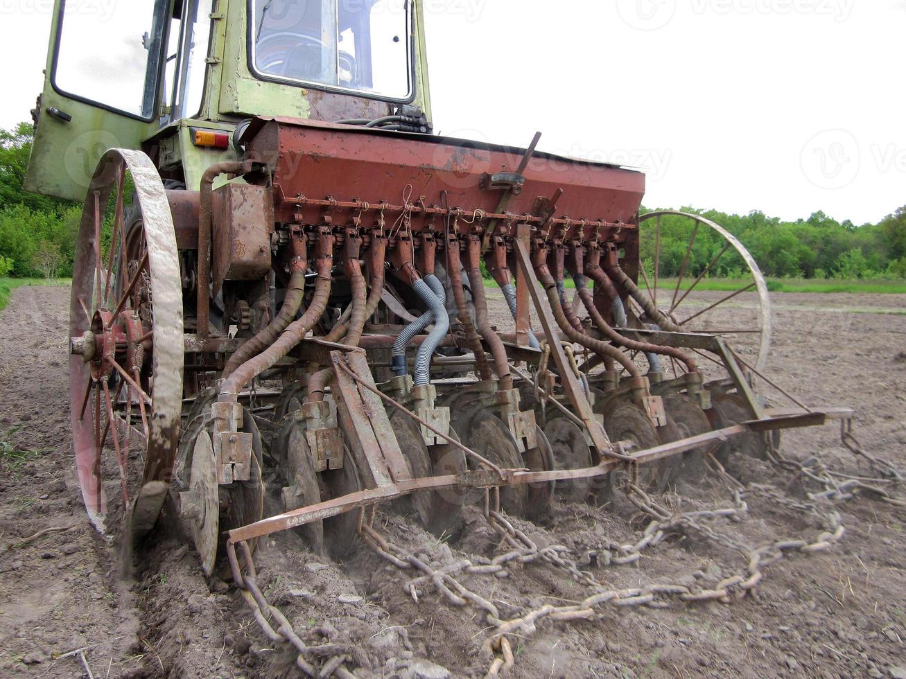 Plowed field by tractor in brown soil on open countryside nature photo