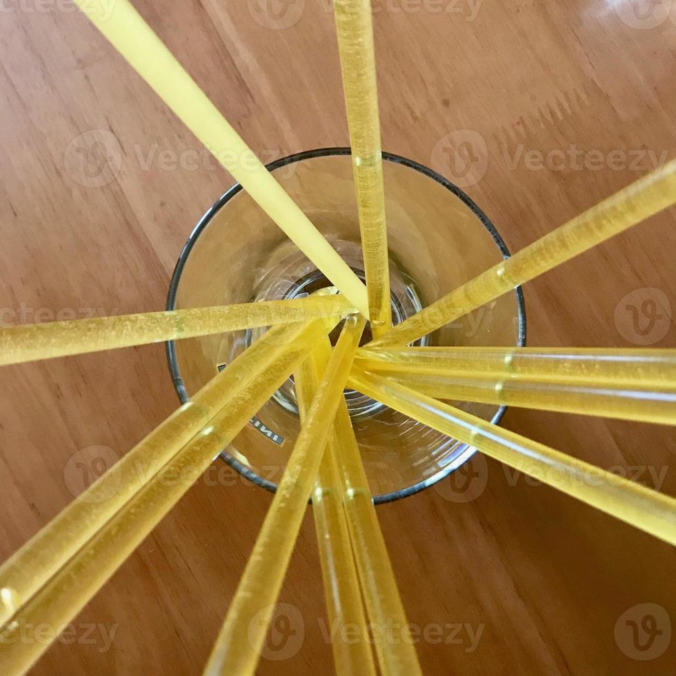 Yellow bee sticks lie beautifully on wooden kitchen table, tasty organic honey dessert photo