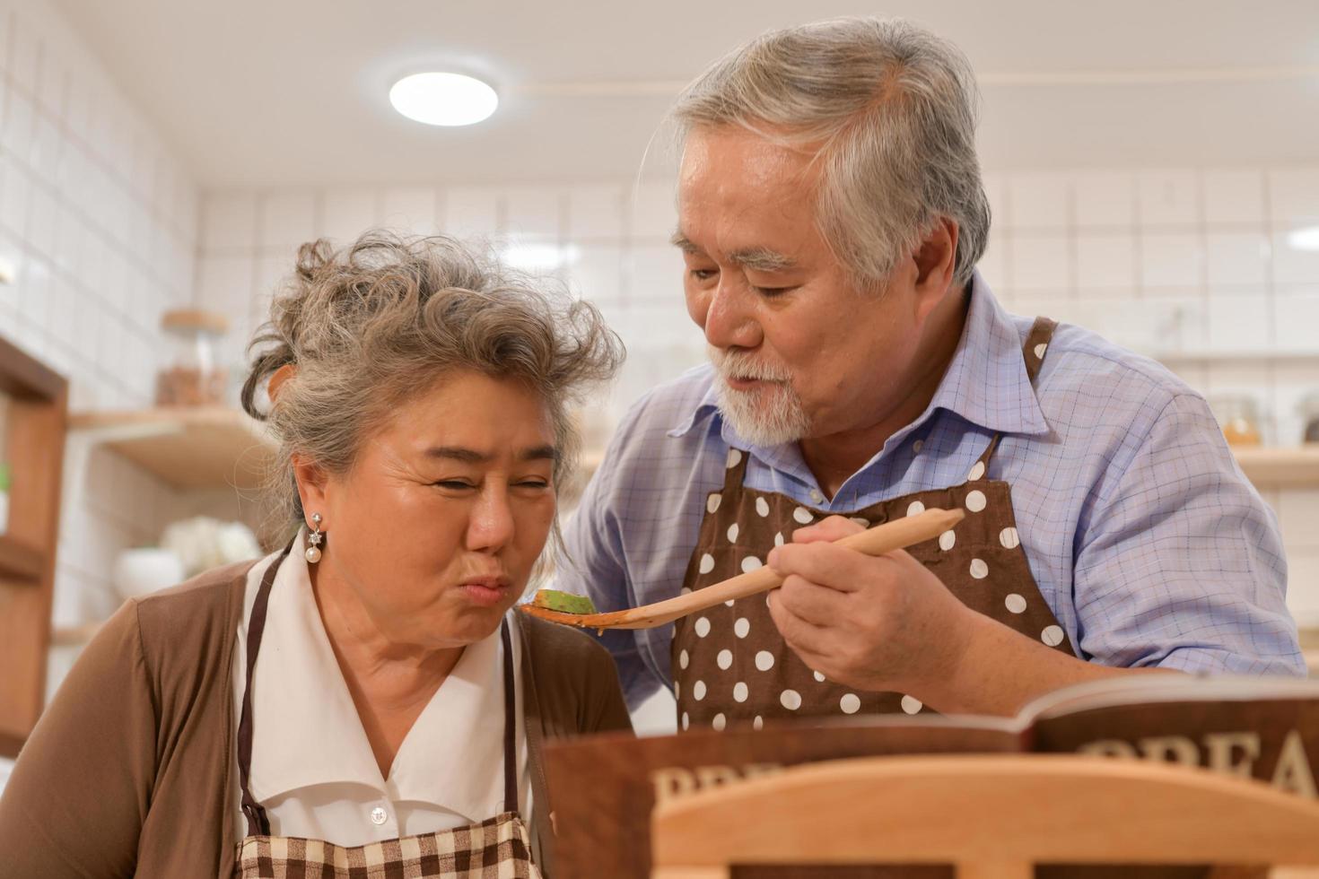 The elderly couples in the kitchen to cook and eat happily in the modern kitchens. photo