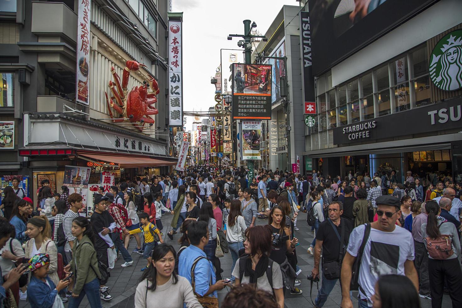 OSAKA, JAPAN, 2016 - Unidentified people on the street of Osaka, Japan. Osakai is known for its modern architecture, nightlife and hearty street food. photo