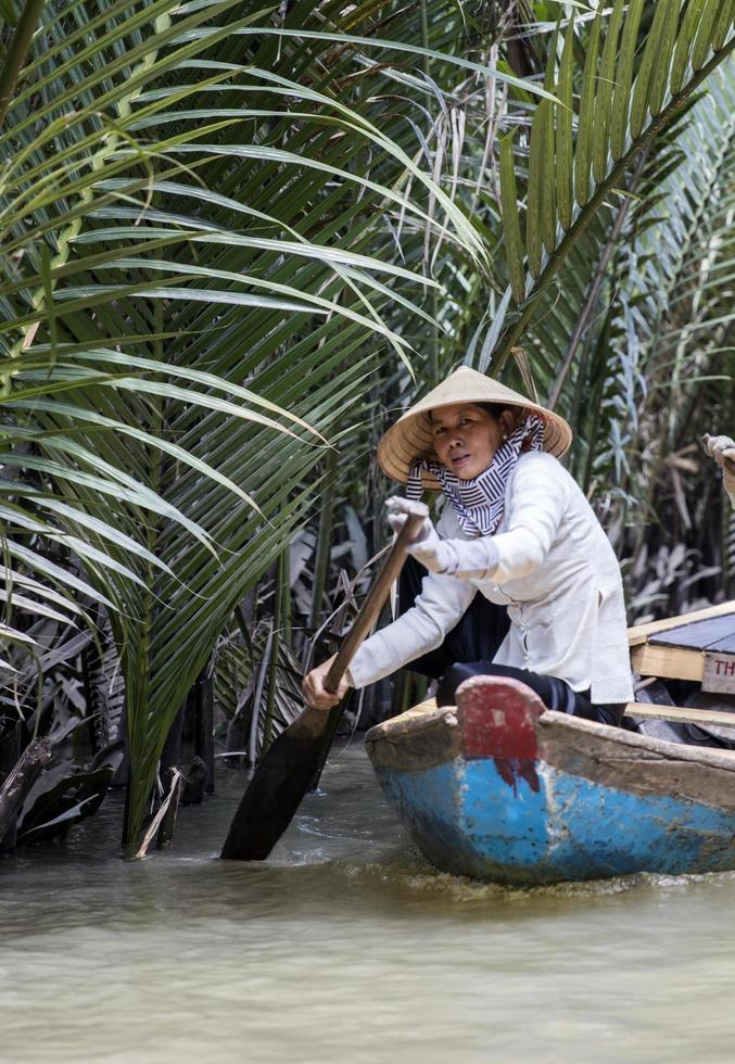 MEKONG DELTA, VIETNAM, 2017 - Unidentified people in the boat at Mekong Delta in Vietnam. Boats are the main means of transportation in Mekong Delta. photo