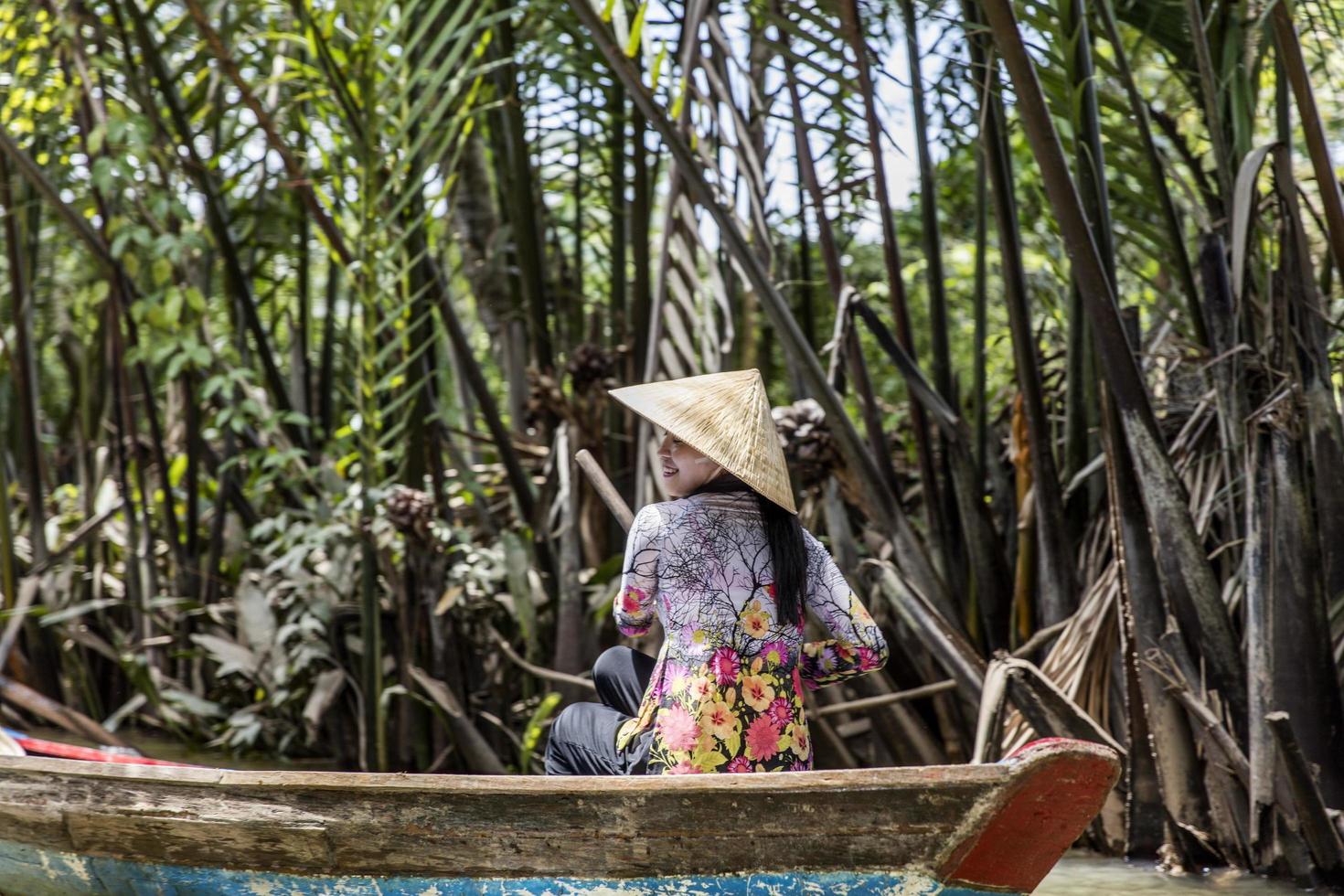 MEKONG DELTA, VIETNAM, 2017 - Unidentified people in the boat at Mekong Delta in Vietnam. Boats are the main means of transportation in Mekong Delta. photo