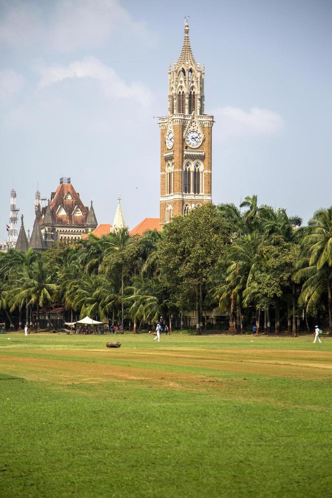 MUMBAI, INDIA, 2015 - Unidentified people playing sqiash by the Rajabai Clock Tower in Mumbai. Tower was completed at 1878 and have height of 85 m. photo