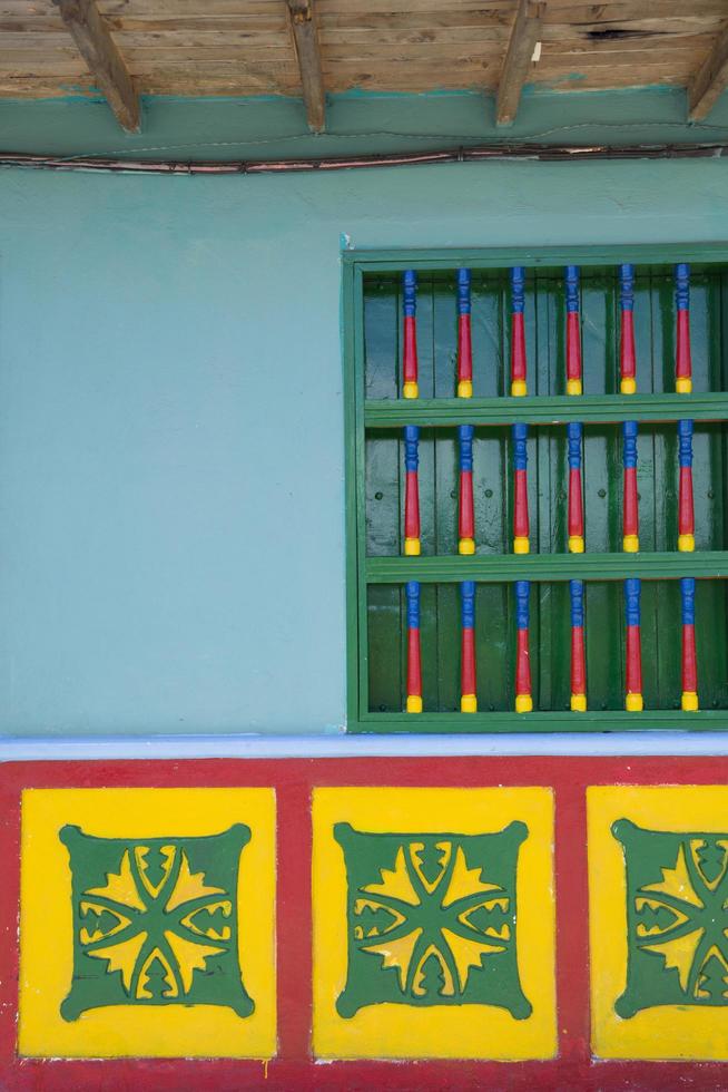 GUATAPE, COLOMBIA, 2019 - Detail from colorful facade on the building in Guatape, Colombia. Each building in town Guatape has bright color tiles along the lower part of facade. photo