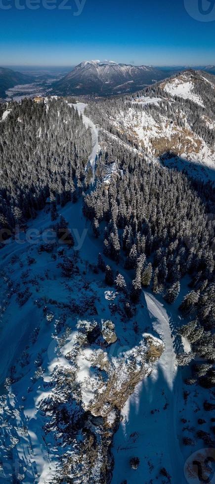 Aerial view over Mountain with snow covered pine trees in Bavaria at Garmisch partenkirchen photo