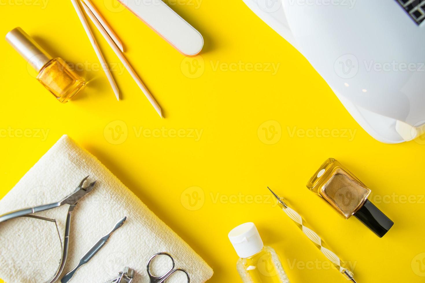 Set of tools for manicure and nail care on a yellow background. photo