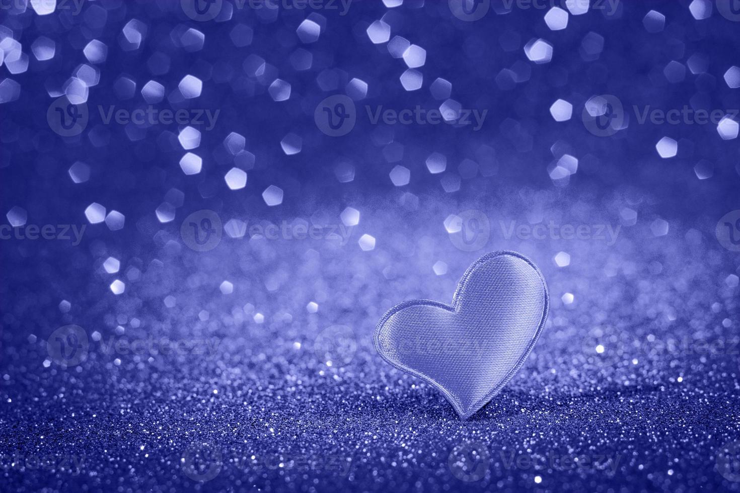 Cute heart for valentine's day on bokeh background. Trendy color of the year 2022. photo