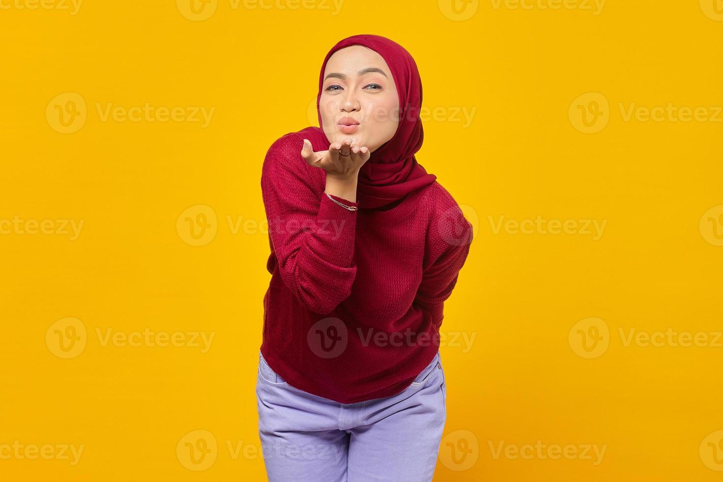 Beautiful Asian woman giving air kiss. Valentine's day concept. photo
